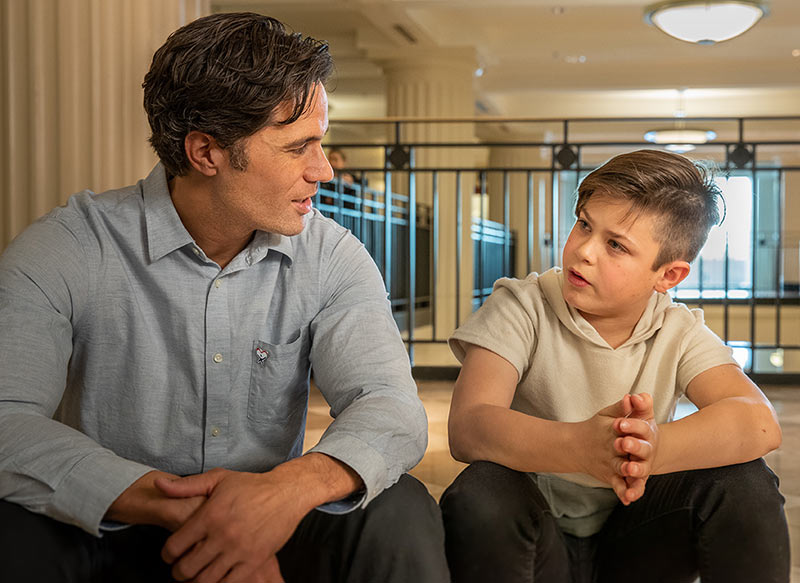 A CASA advocate talking with a young boy