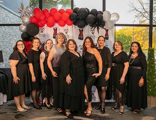 A group of CASA volunteers at a formal event