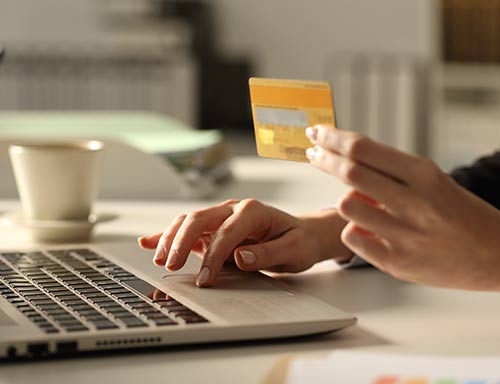 a woman making an online donation on her laptop